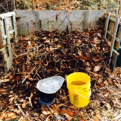 Outdoor Compost Pile With Bucket of Ash and Water